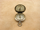 A late Victorian hunter cased pocket compass with gemstone needle